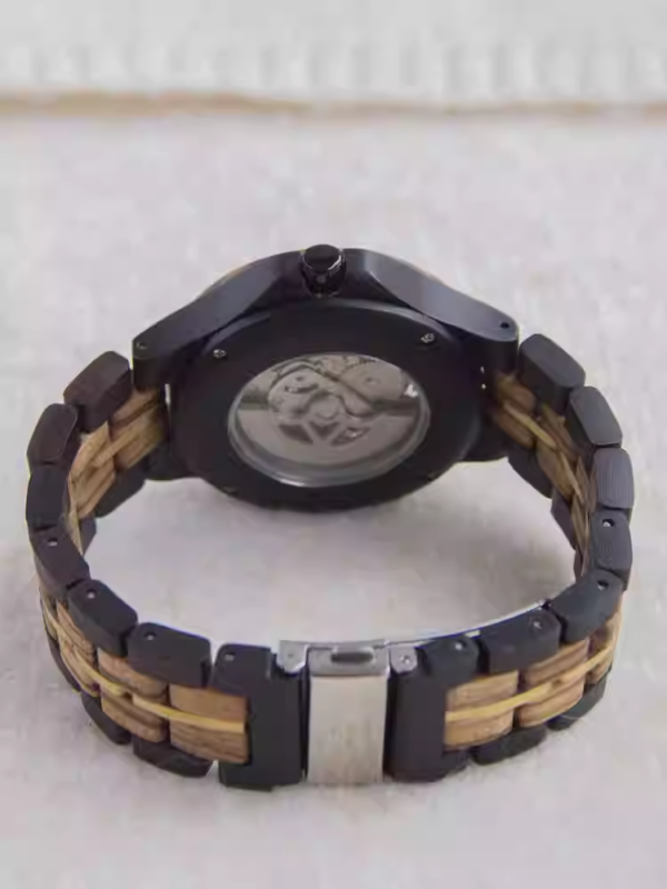 Black and gold transparent round skeletonized wooden men's automatic winding wooden watch with gold hands.